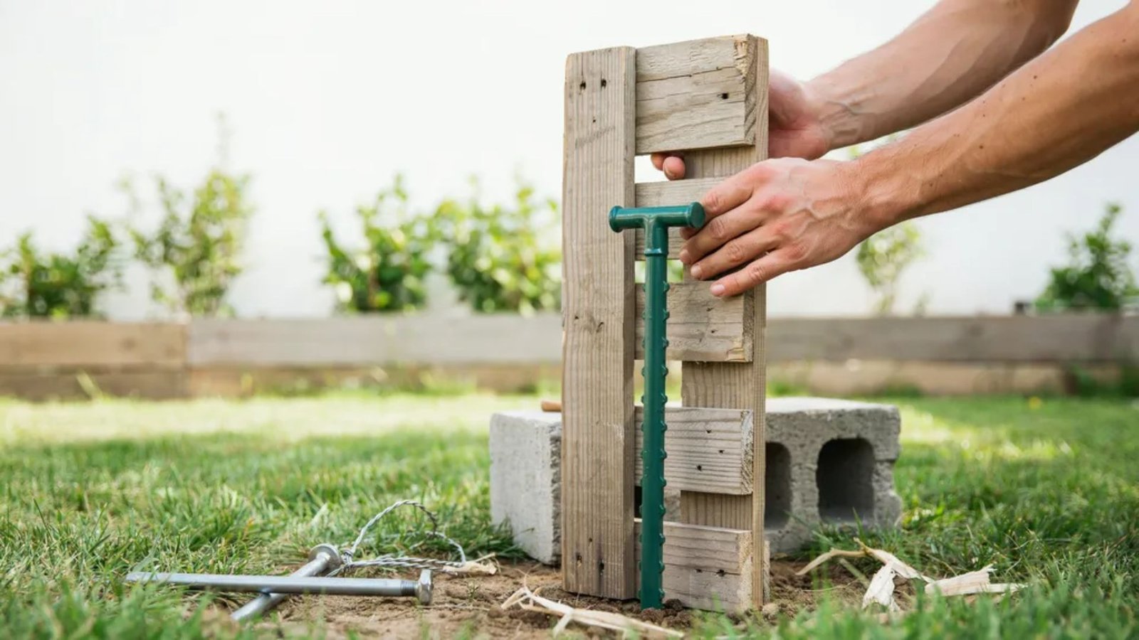 standing a pallet upright and securing it with a T-post.