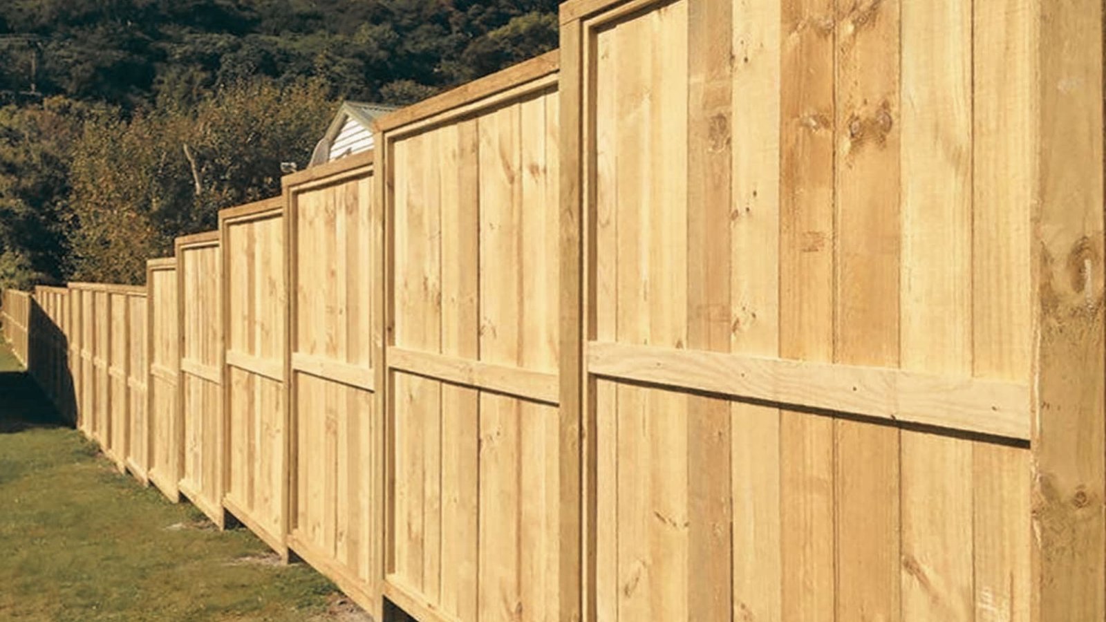 Completed step down wood fence on slope ready for final finish
