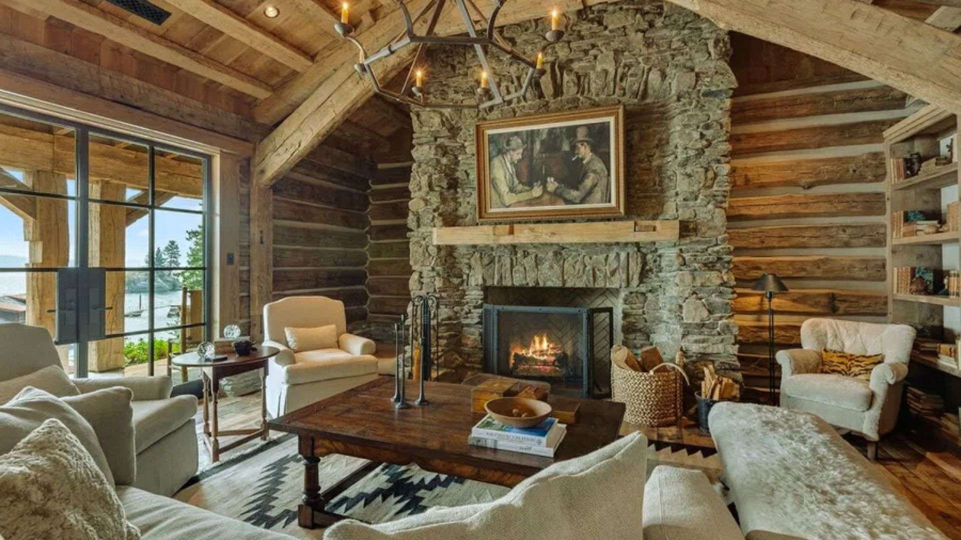 Rustic cabin shed tiny house interior - stone fireplace, log walls, timber beams and cozy seating area