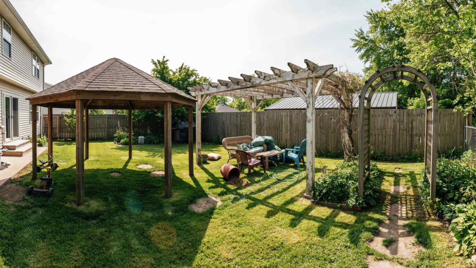 Backyard showing common outdoor structure planning mistakes, including poor spacing, maintenance issues, and an oversized installation.