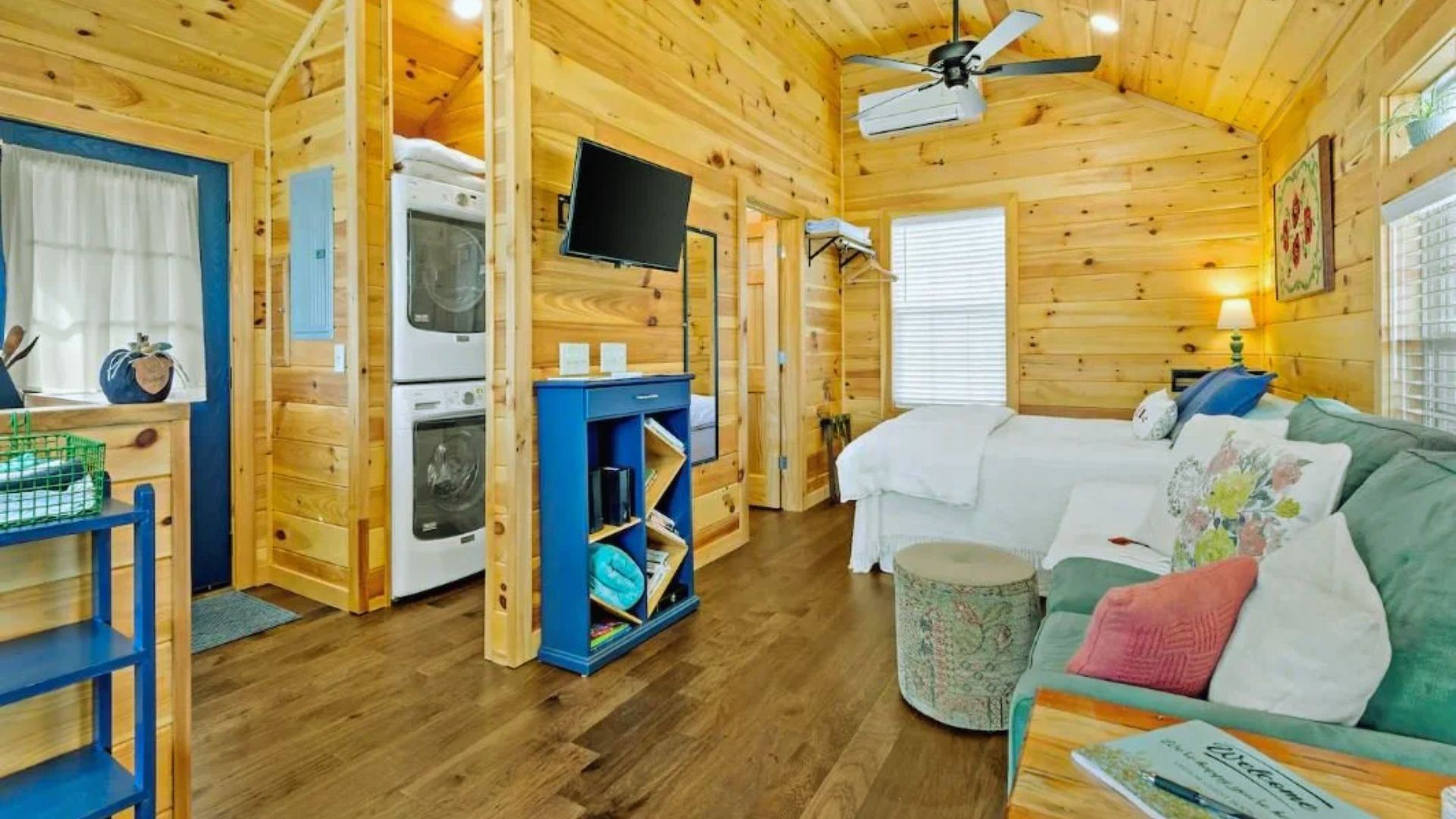 Choosing interior style for shed tiny house - cozy cabin with knotty pine walls, blue accents and open studio layout