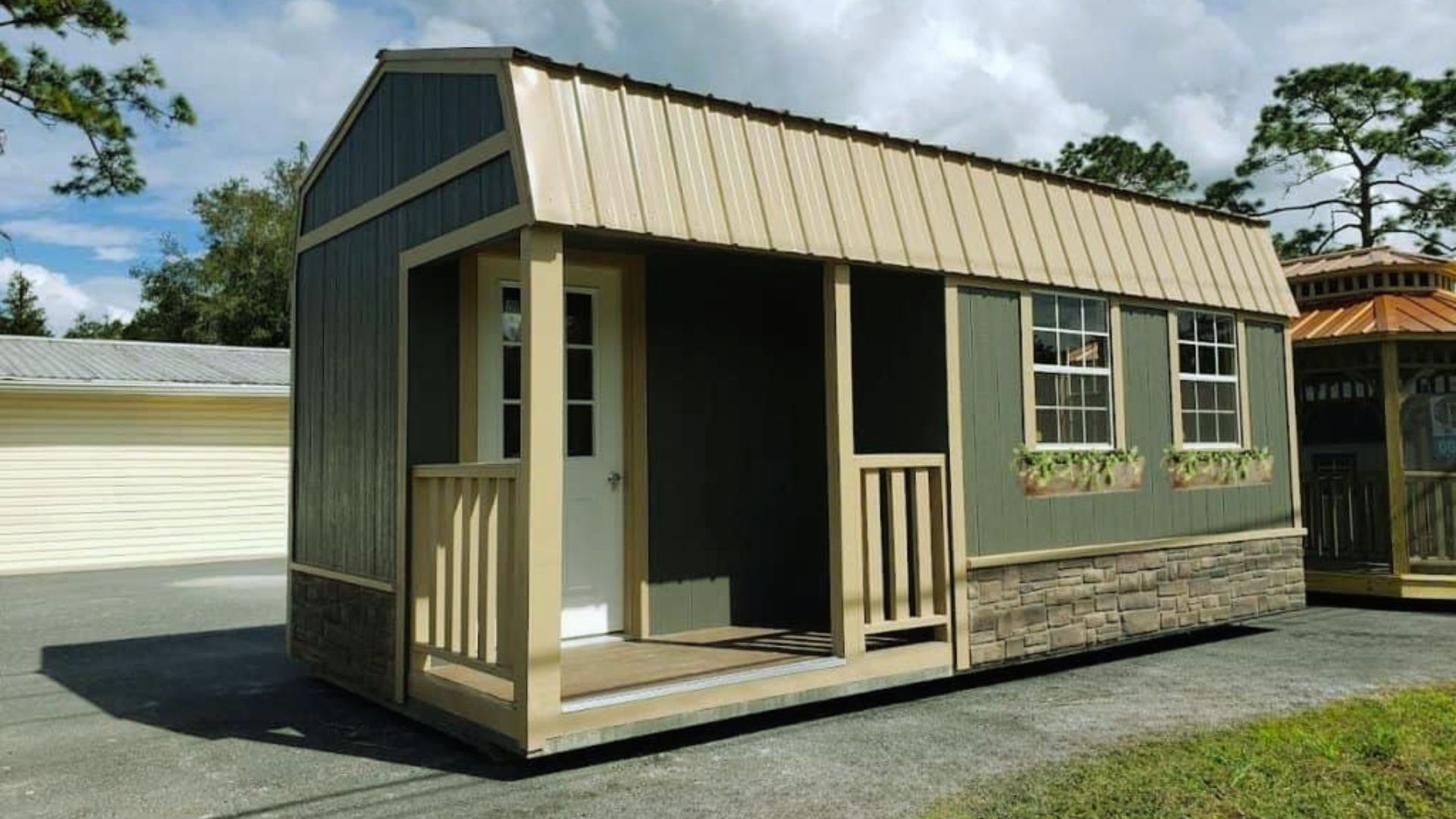 lofted barn cabin with front porch, metal roof and stone skirt exterior