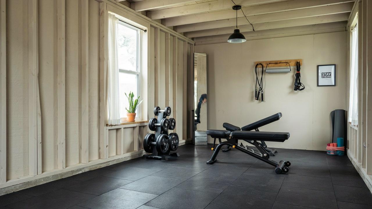 Compact home gym inside a 12x16 shed.