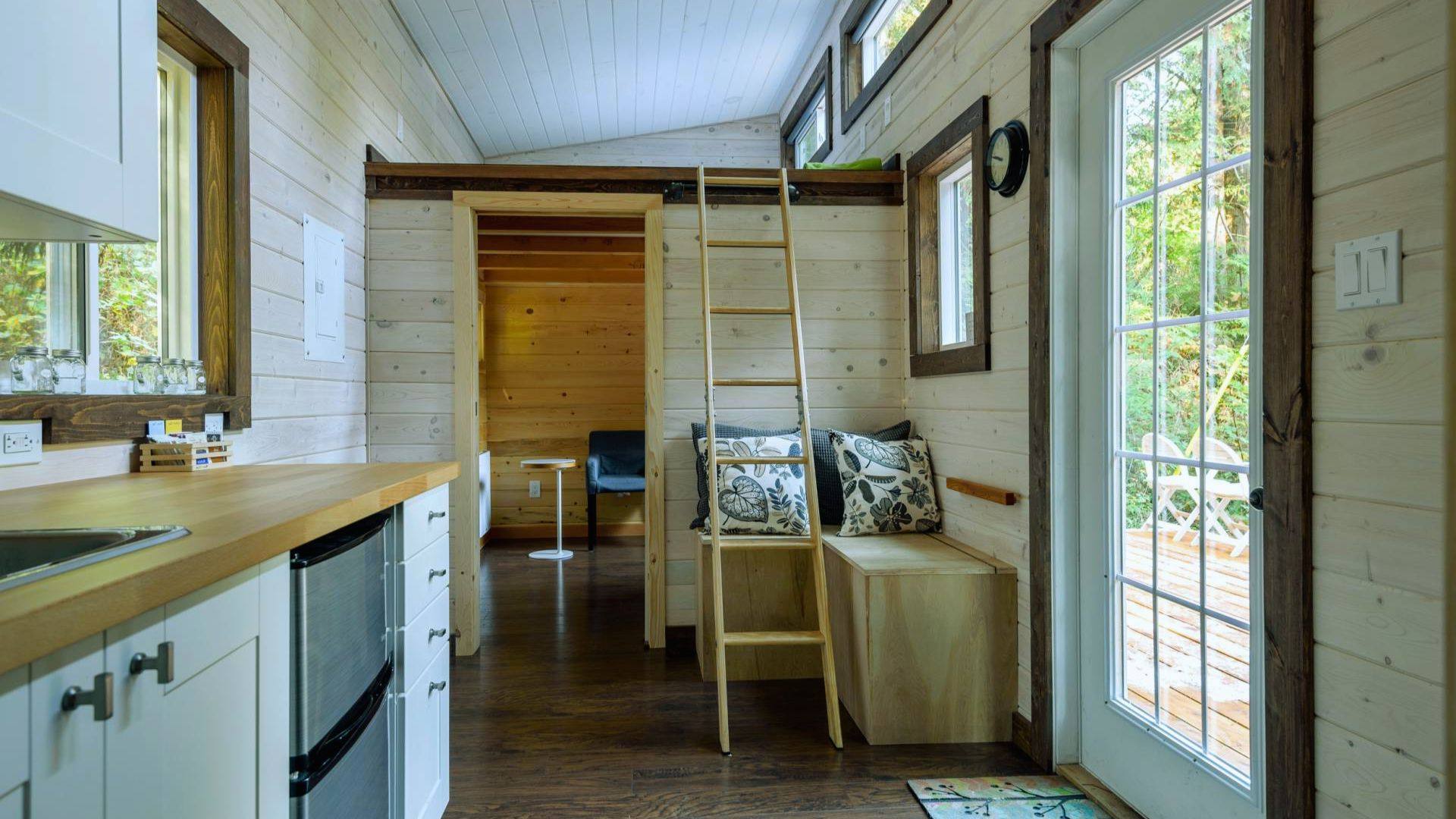 Window placement for natural light and ventilation - shed interior with glass door, loft windows and cross-breeze windows
