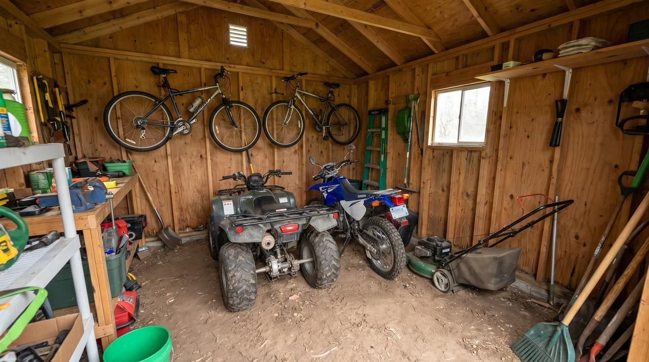 Shed storing bicycles, ATV, motorcycle, and lawn mower with clear access space