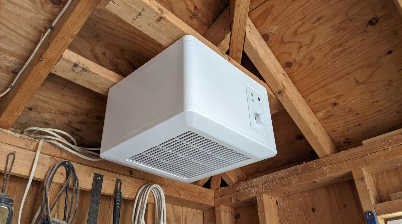 Ceiling-mounted air filtration unit with vented grille in a workshopFile name- woodworking-dust-collection