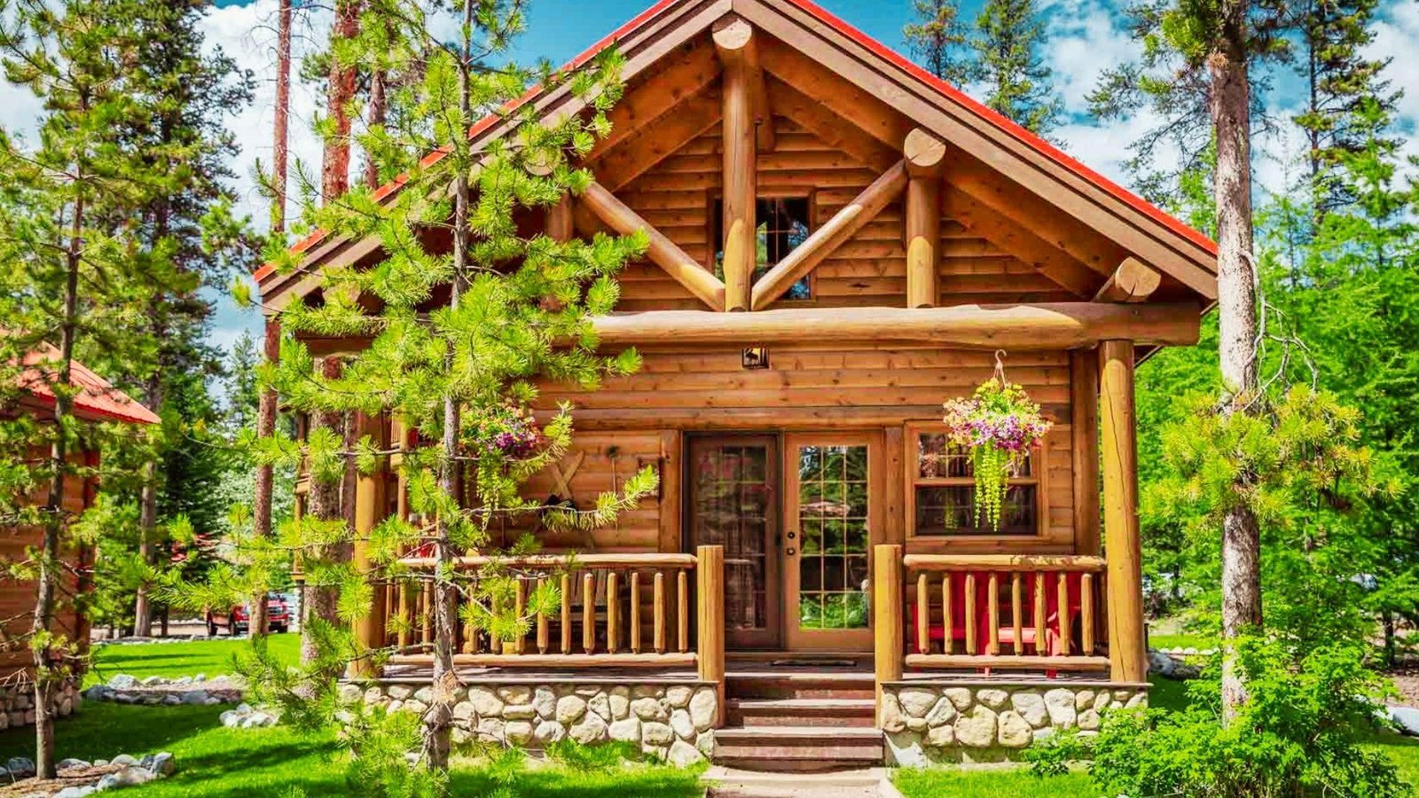 A rustic log cabin situated in a peaceful forest, with trees framing the structure.