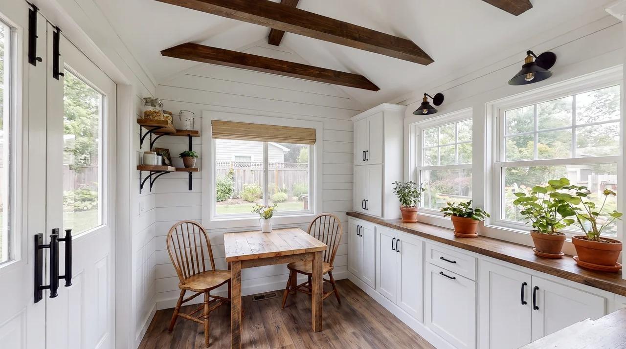 Farmhouse she shed with shiplap walls, wood accents, and small table