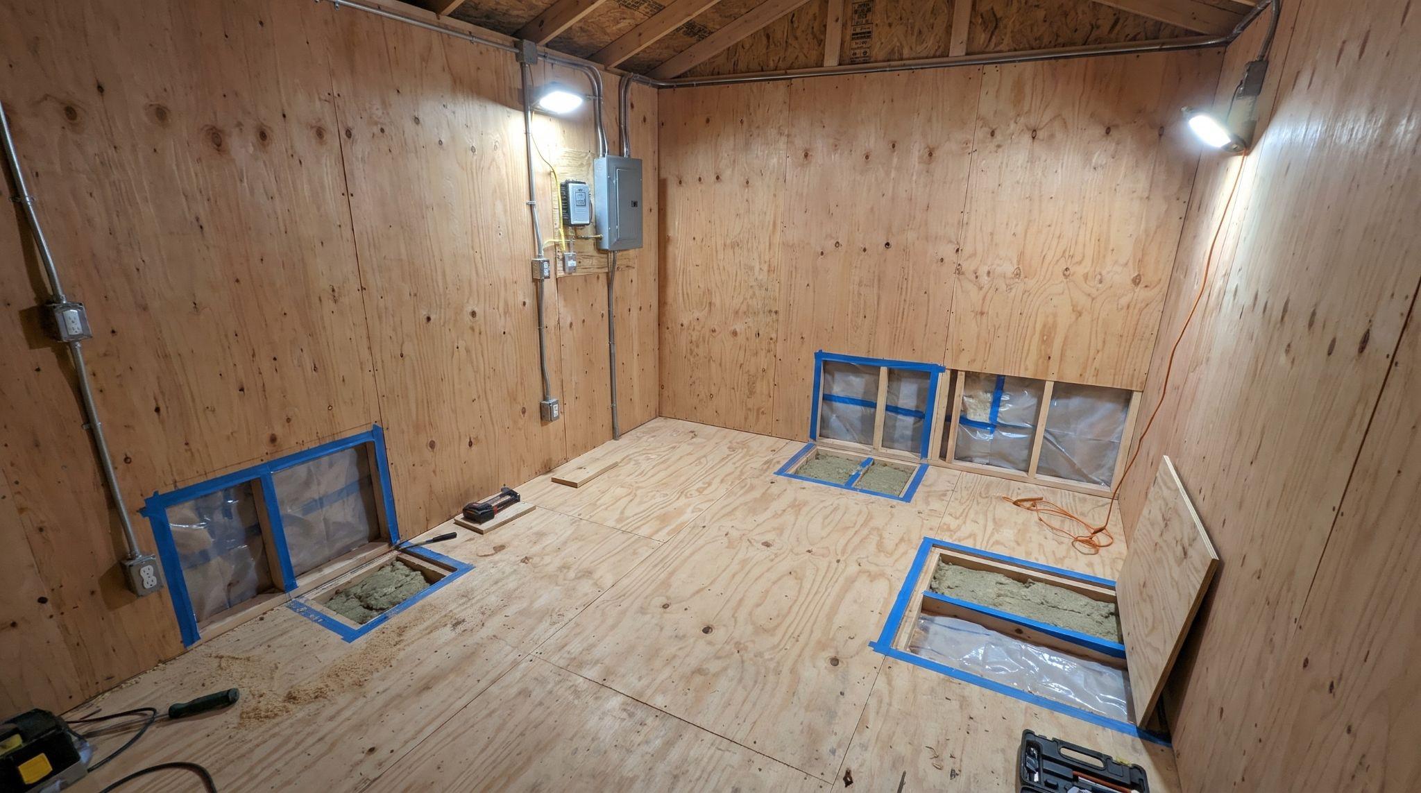Finished shed interior with walls, floor, wiring, and trim